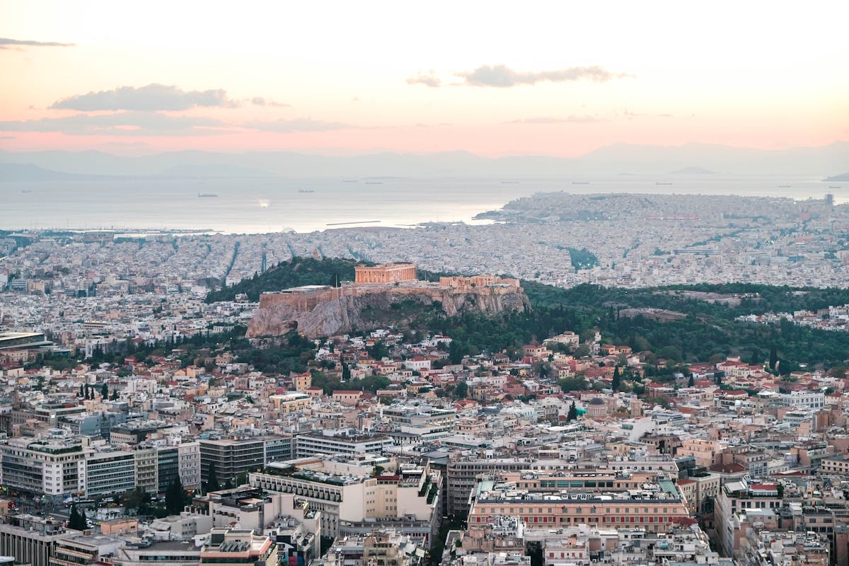 Aerial view of the Acropolis and Athens cityscape at sunset — where to stay in Athens Greece