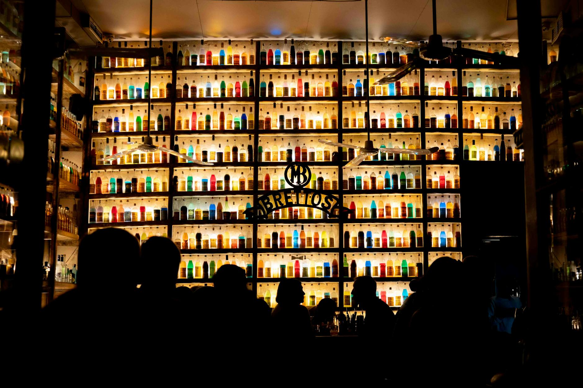 Athens nightlife scene with bars and restaurants lining a busy pedestrian street at night