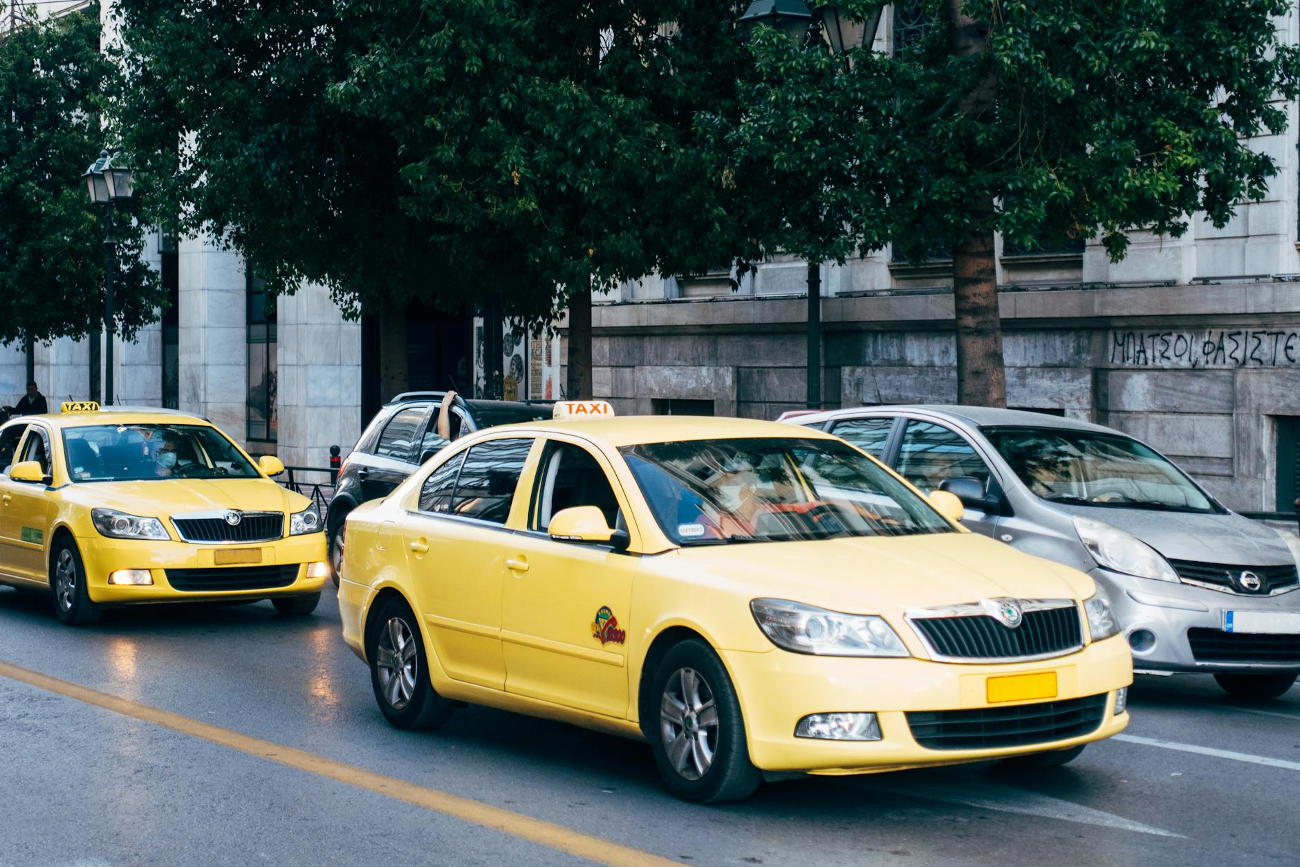 Yellow taxi cab on a busy Athens street providing city transport for tourists and locals