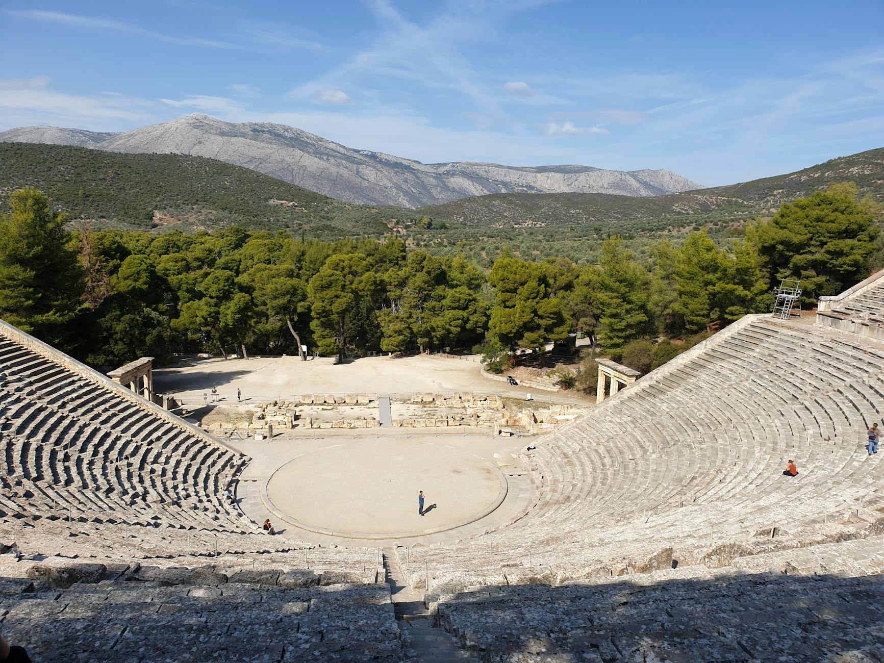 Panoramic view of the ancient Epidaurus theatre surrounded by green hills in Greece