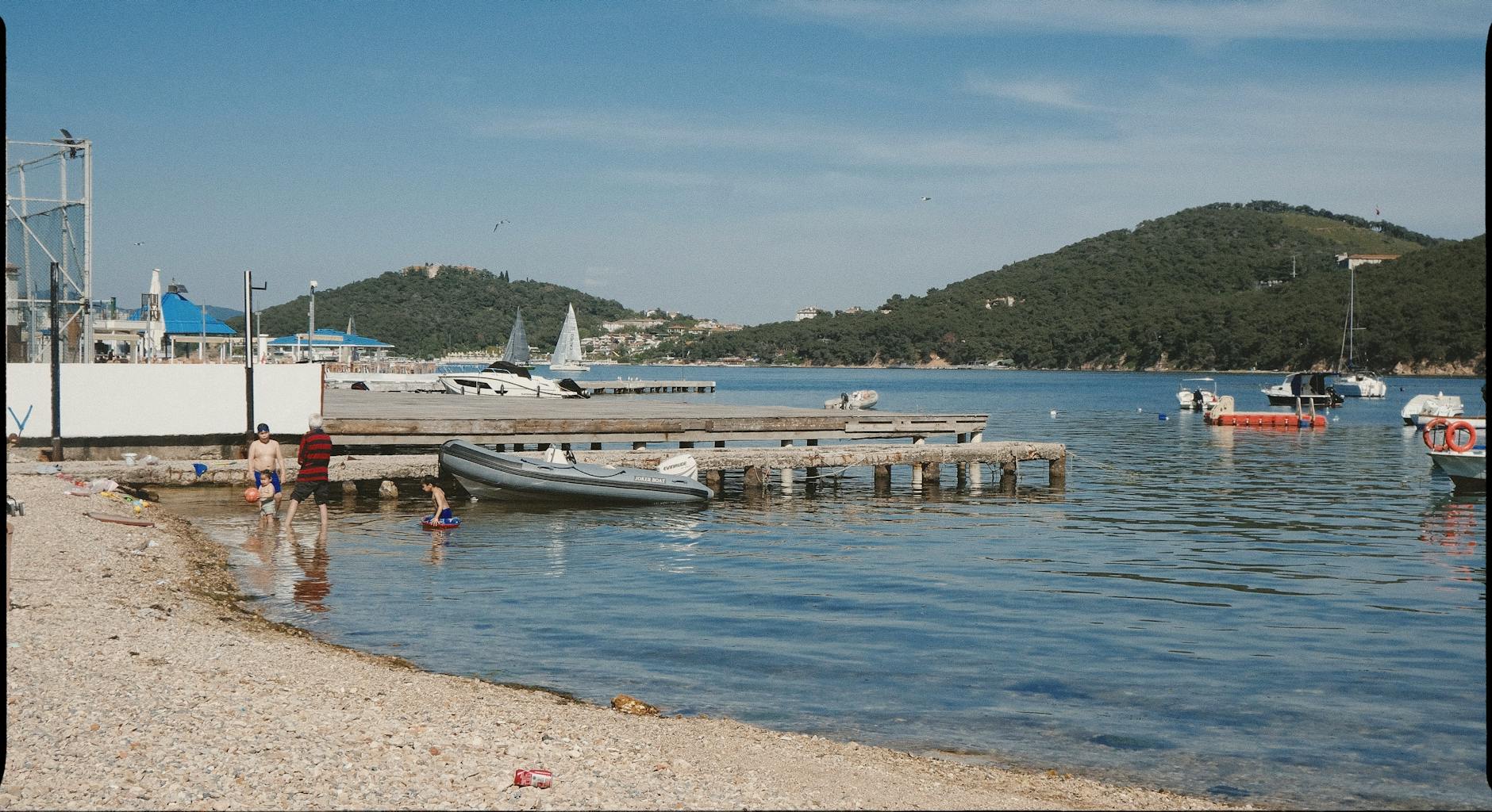 Family enjoying swimming at a calm sandy beach near Athens Greece
