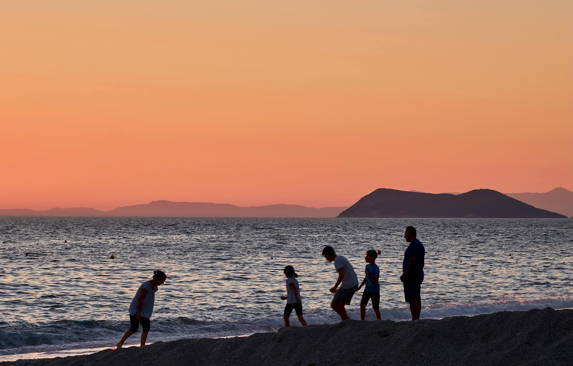 Family watching sunset on a Mediterranean vacation