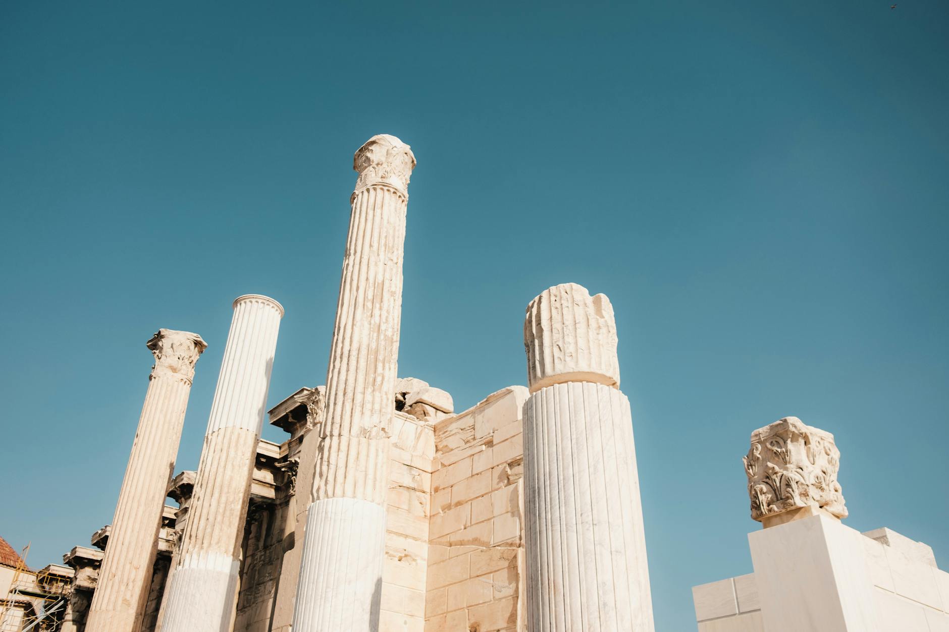 Majestic Corinthian columns of Hadrians Library against blue sky in Athens Greece