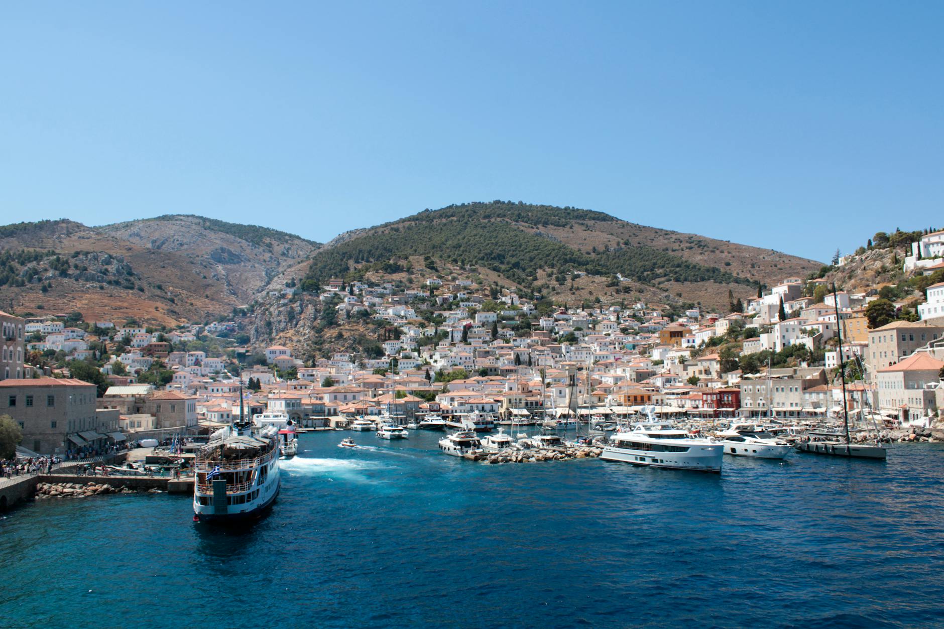 Vibrant harbor of Hydra Island Greece with colorful boats and traditional stone buildings