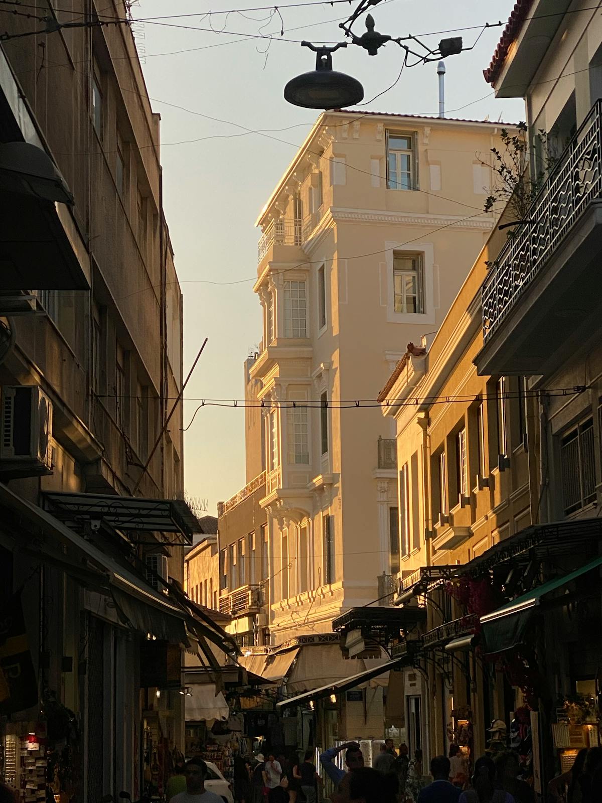 Sunlit alleyway in Koukaki neighborhood Athens with charming cafes
