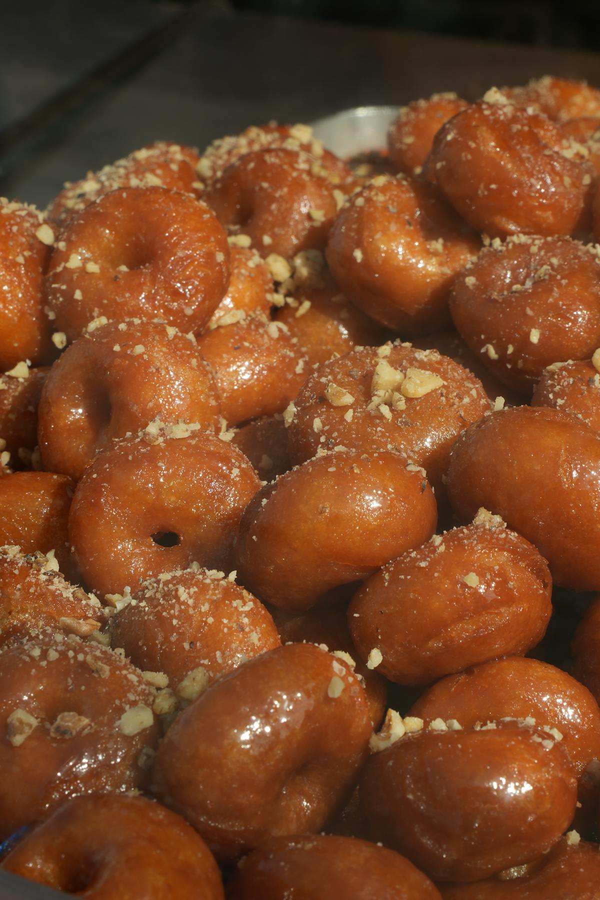 Loukoumades Greek honey glazed donuts topped with crushed nuts