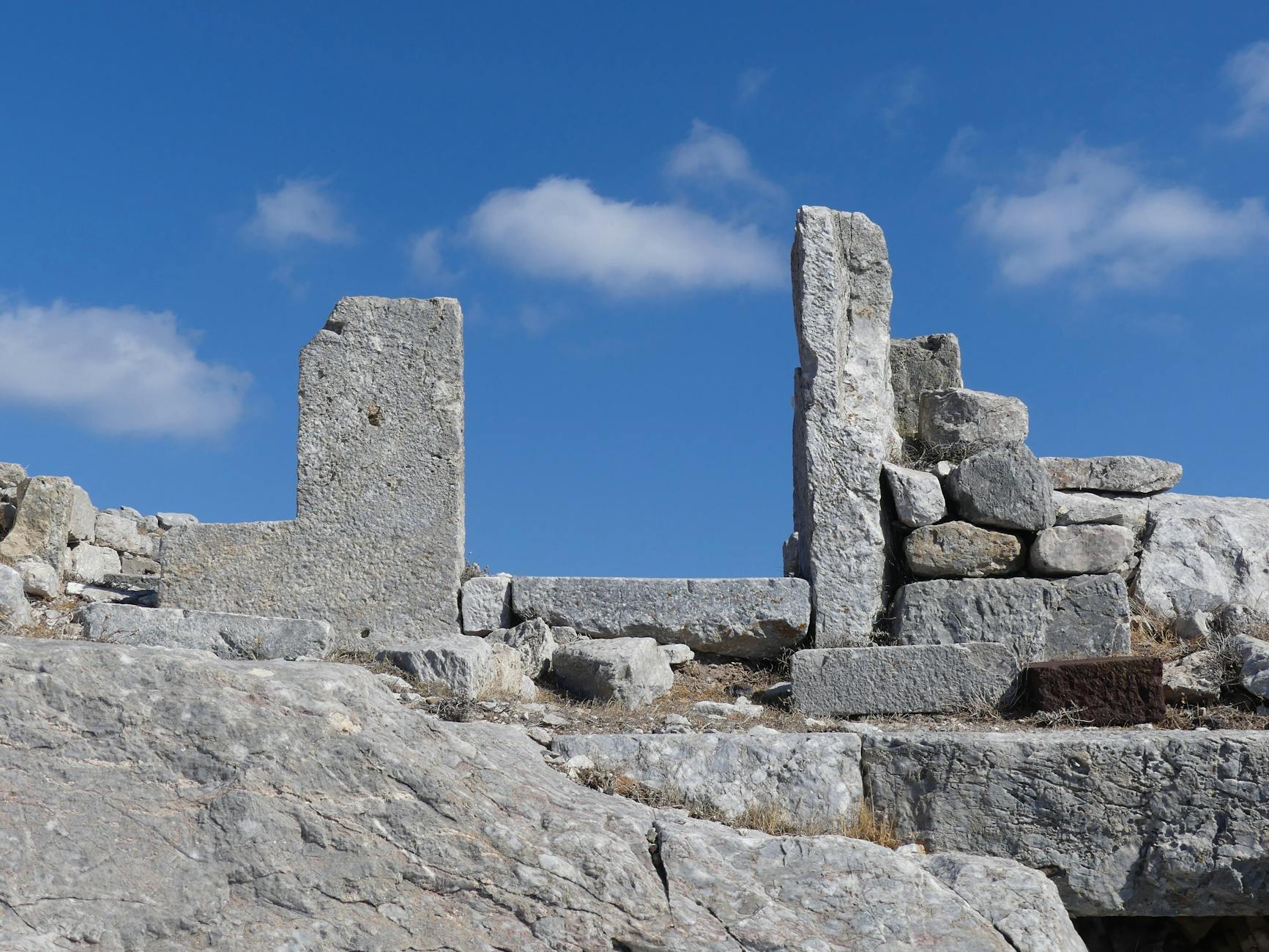 Ancient stone ruins of Mycenae archaeological site under clear blue sky in the Peloponnese Greece