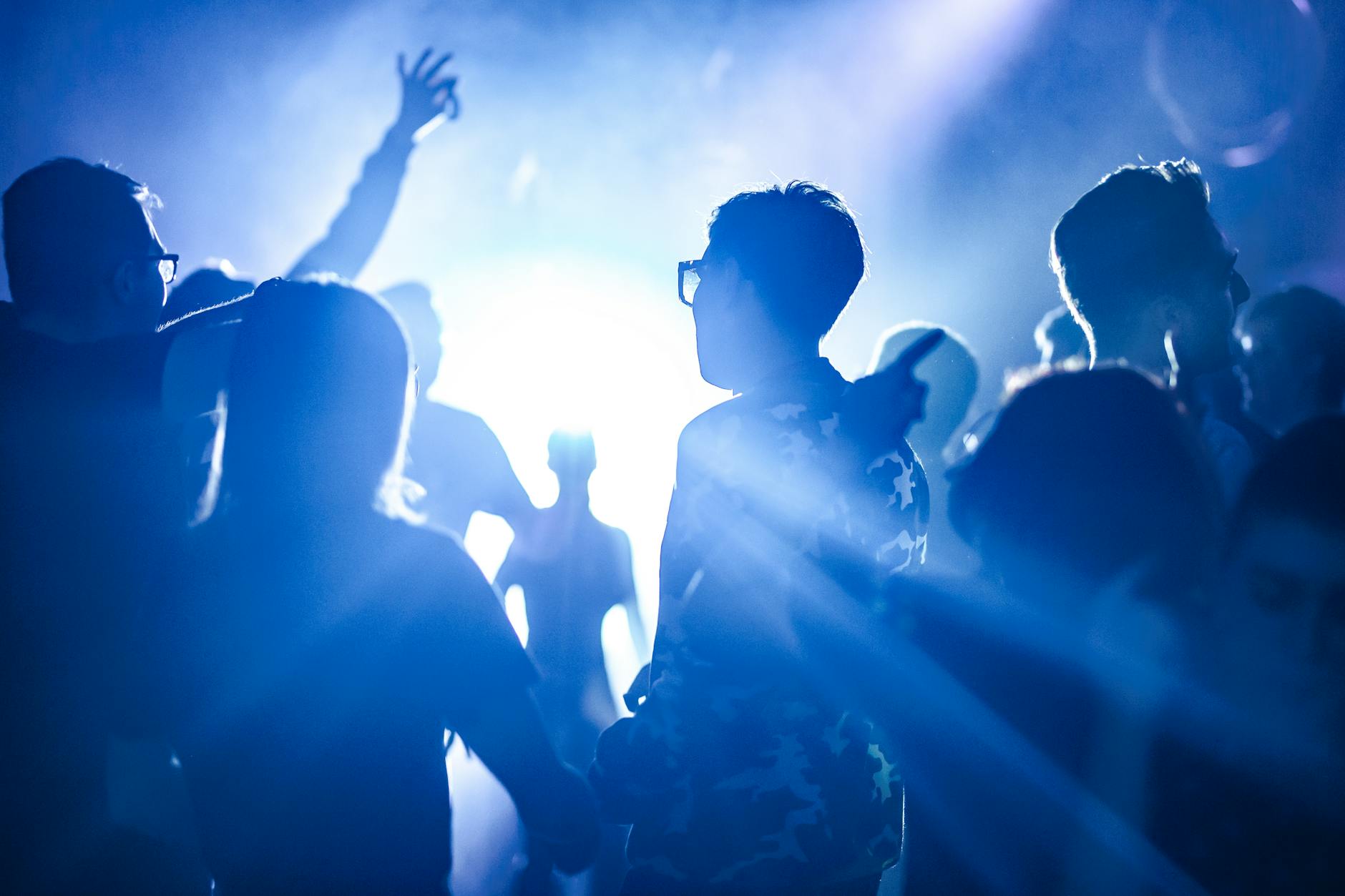 People dancing at an Athens nightclub with colorful lights
