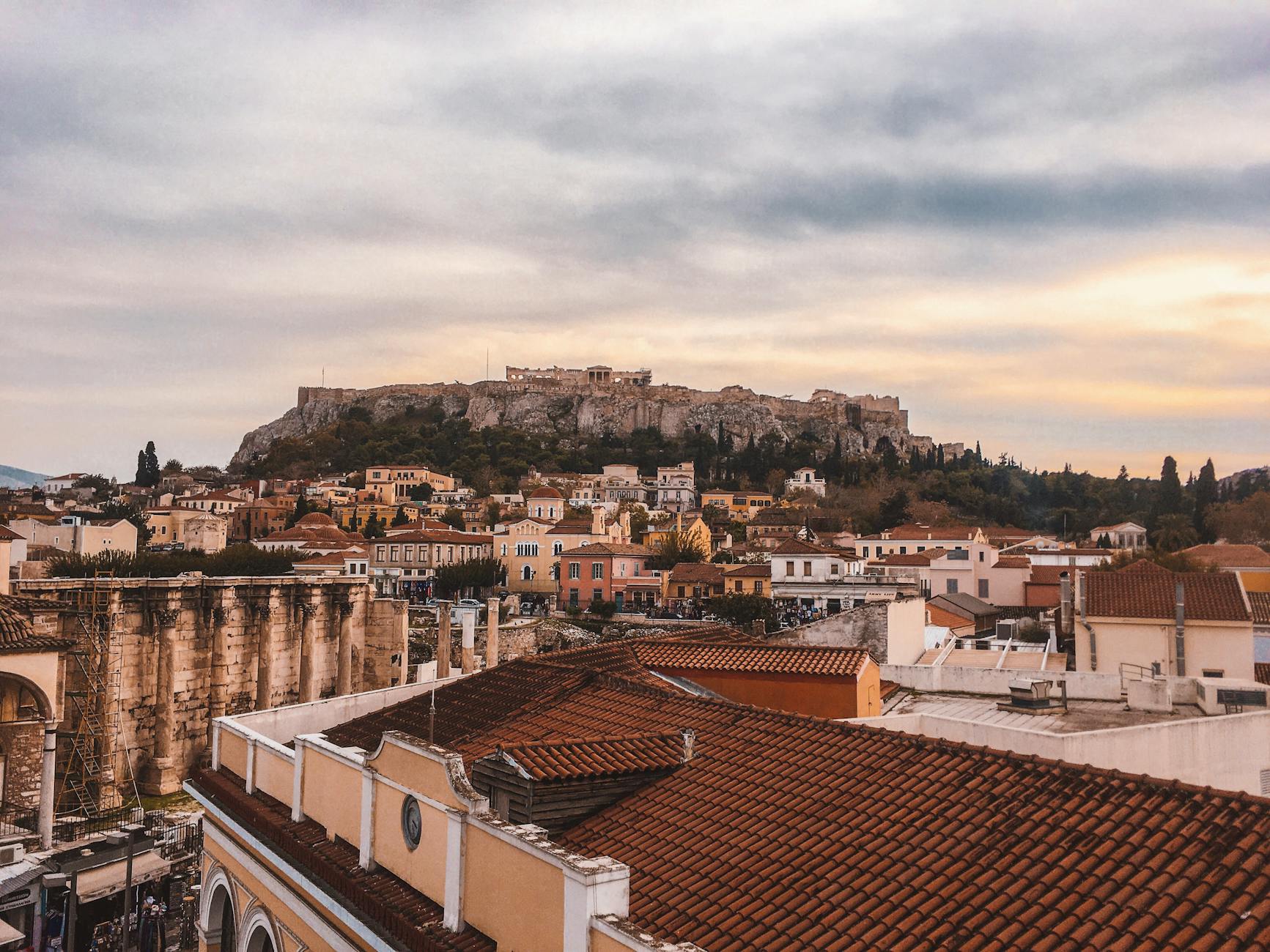 Cocktail on a rooftop terrace with a view of the illuminated Athens Acropolis