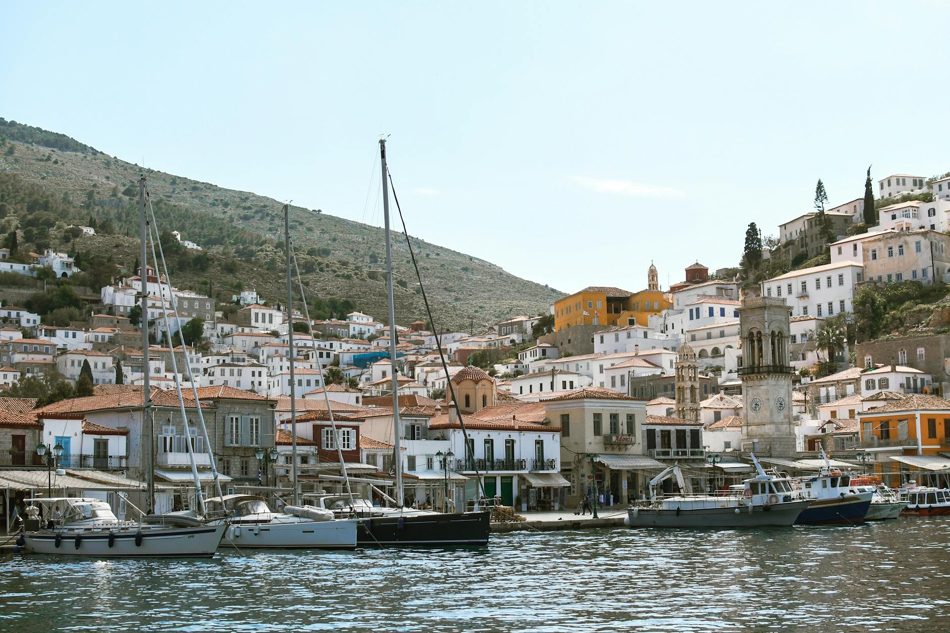 Charming Hydra town with boats moored along the scenic waterfront in the Saronic Gulf Greece