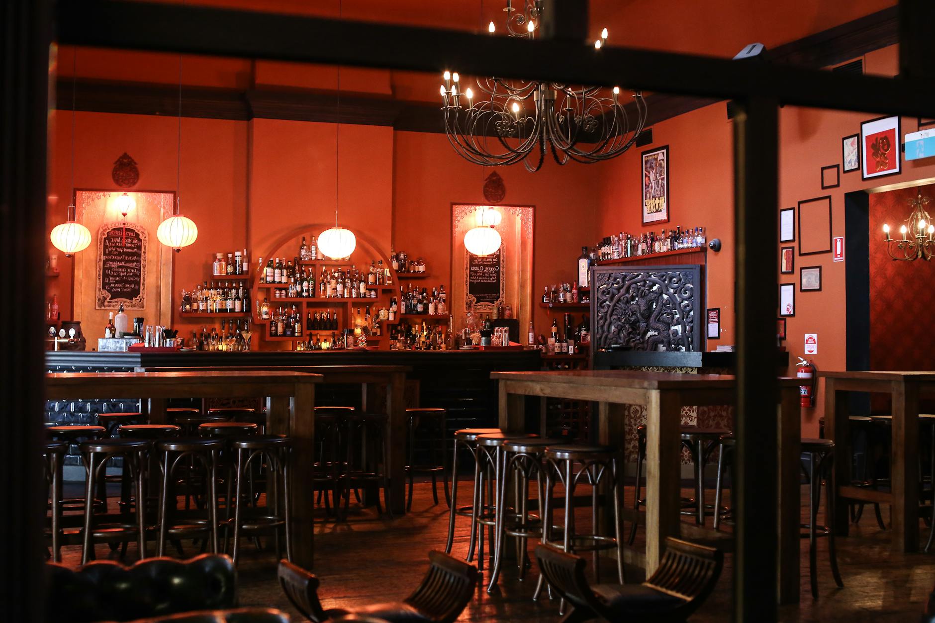 Interior of a dimly lit speakeasy cocktail bar in Athens
