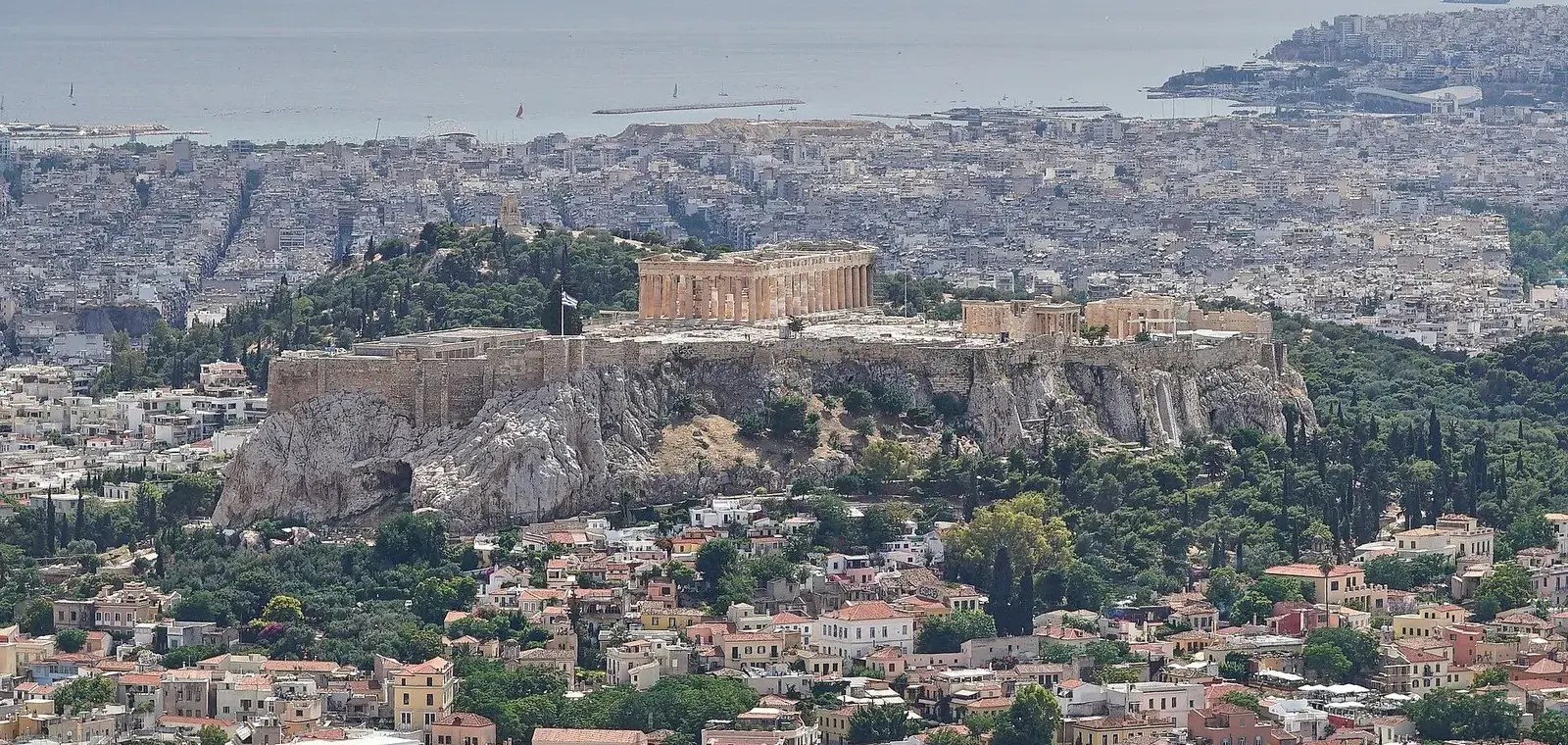 The Acropolis rising above central Athens, seen from Mount Lycabettus, with Piraeus and the Saronic Gulf behind