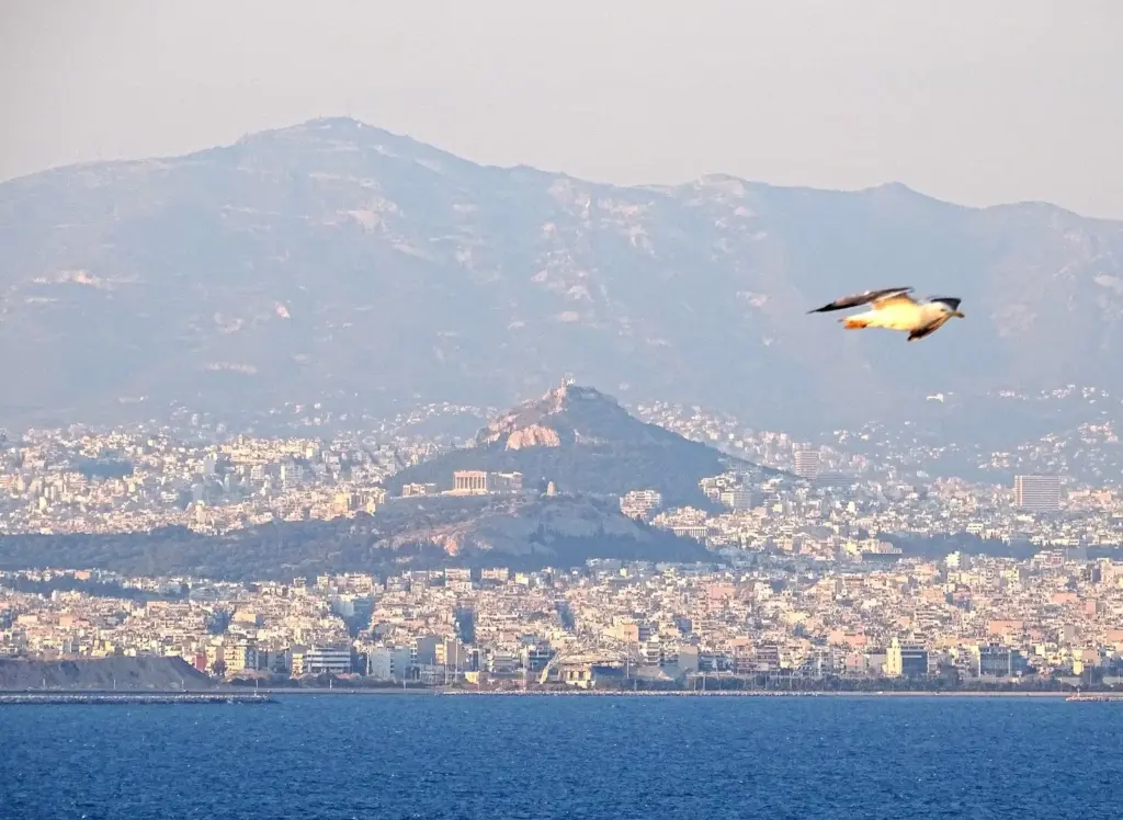 The Acropolis and Lycabettus Hill seen from the sea off Piraeus