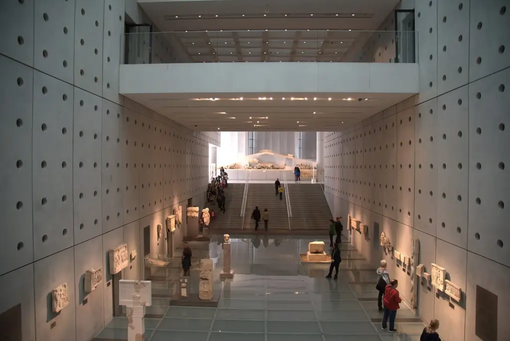 The ramped entrance gallery of the Acropolis Museum, with finds from the Acropolis slopes along both walls