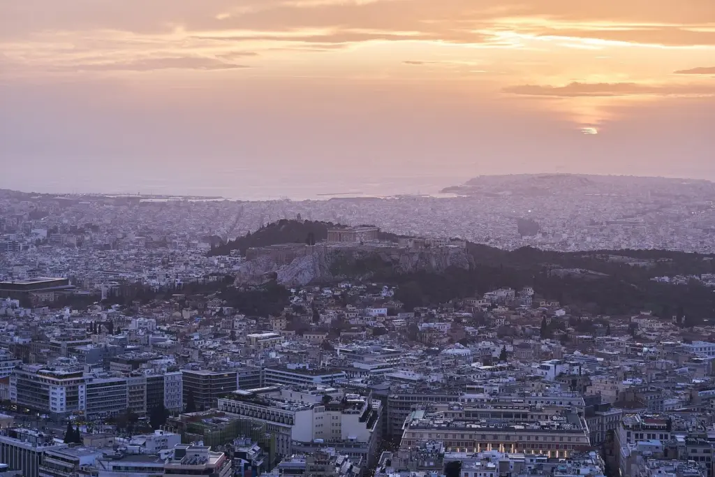 The sun setting over the Saronic Gulf just right of the Acropolis, seen from Lycabettus in December