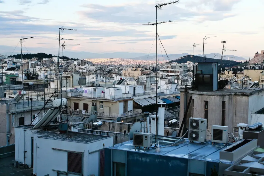 Athens apartment rooftops with television aerials, air-conditioning units and a solar water heater