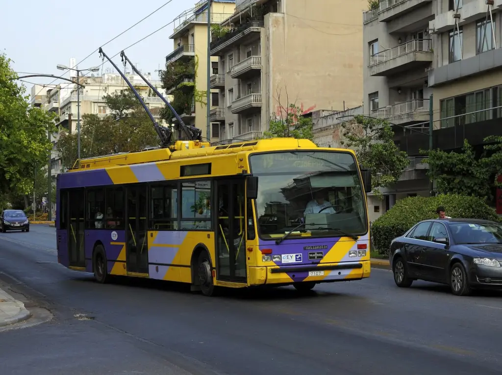 Yellow Athens trolleybus driving along Alexandras Avenue