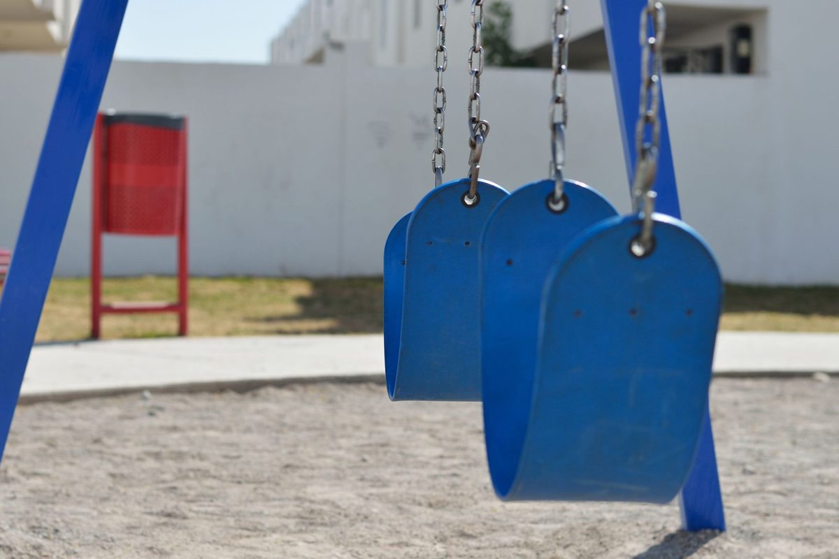 An empty playground. Go before 10:30 or after 18:00 — midday equipment gets dangerously hot.