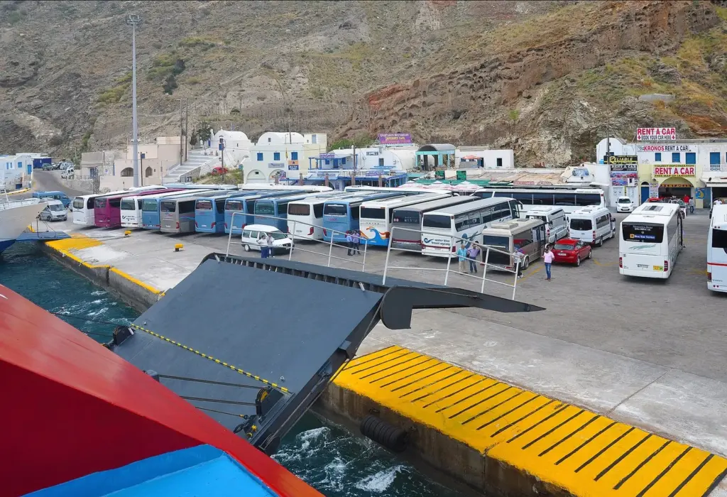 Coaches and hire cars waiting on the quay at Athinios port, Santorini
