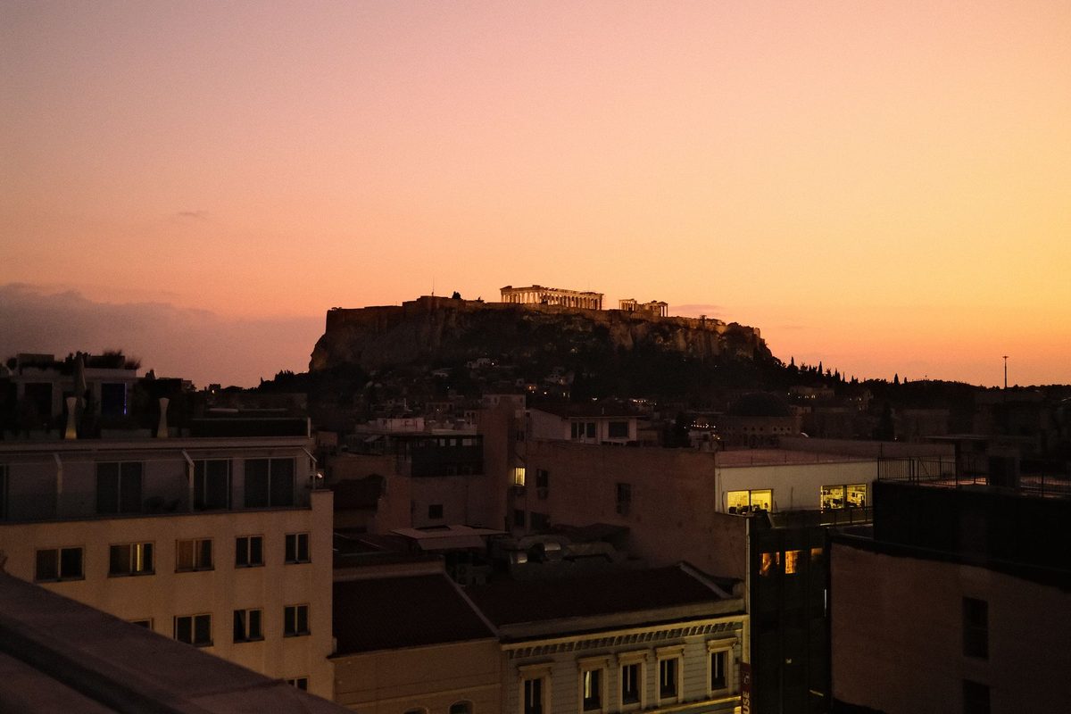 The Acropolis at dusk. Rooms with this view carry a premium of roughly 25 to 40 per cent.