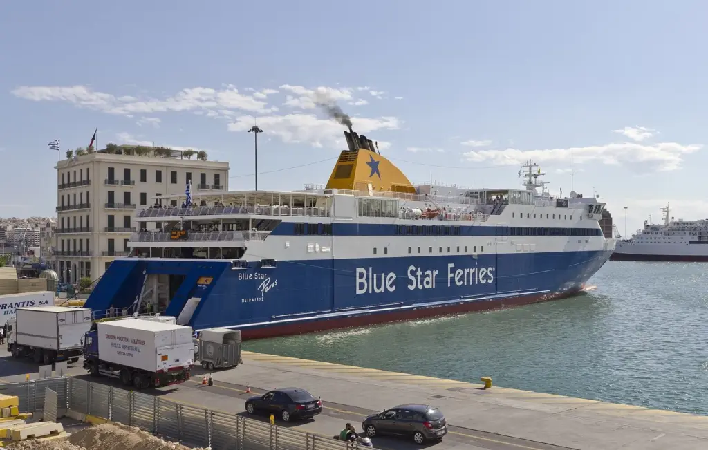 Blue Star Ferries ship moored at Piraeus port with lorries lined up on the quay