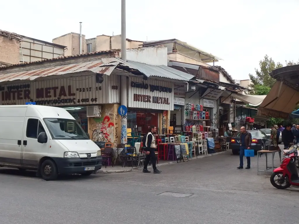 Shopfronts and a parked van at the corner of Ermou and Normanou streets near Monastiraki