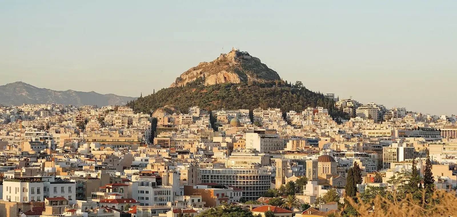Lycabettus Hill rising above central Athens in evening light, seen from the Areopagus