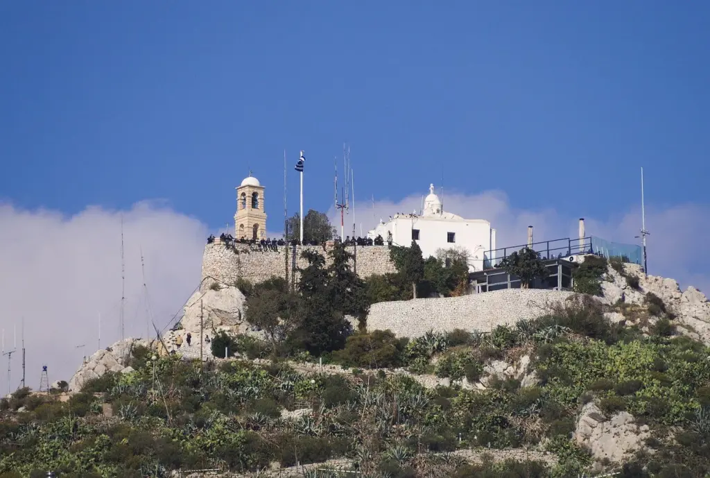 The summit of Lycabettus with its bell tower, flagpole and white chapel on a narrow rocky platform