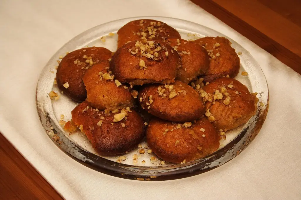 Plate of melomakarona, Greek honey-soaked Christmas biscuits topped with walnuts