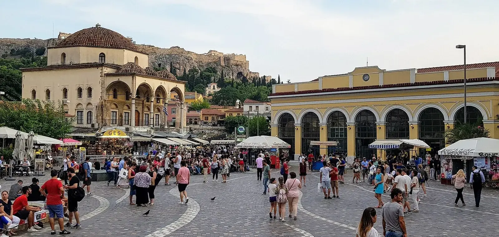 Monastiraki Square with the Tzistarakis Mosque, the metro station arcade and the Acropolis rising behind