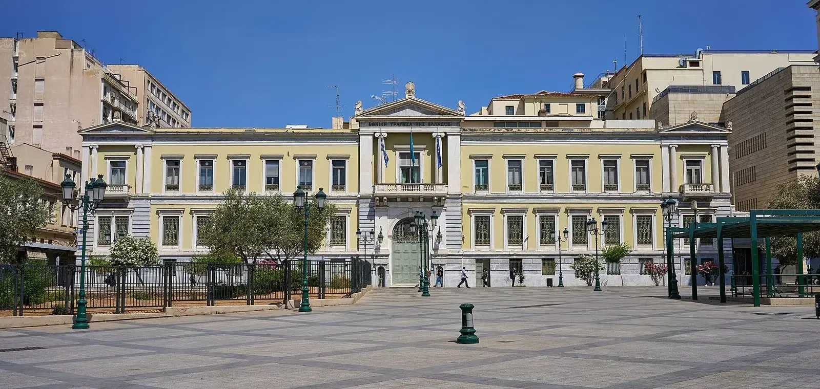 Neoclassical head office of the National Bank of Greece on Aiolou Street in central Athens under a blue sky