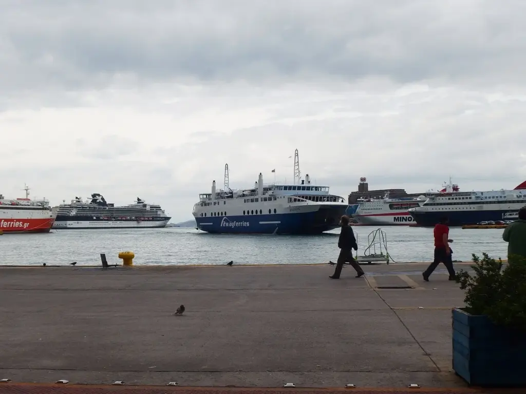 Passenger ferries moored along the quay at Piraeus port on a cloudy day