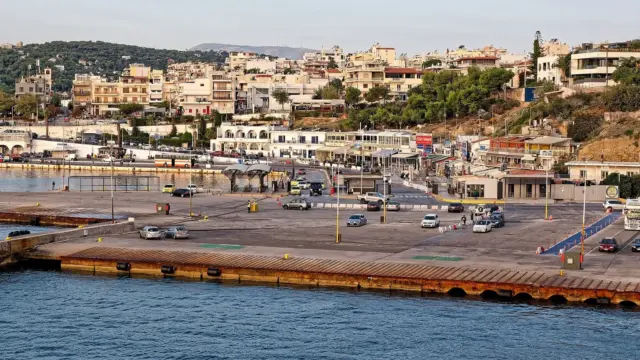 Rafina port ferries from Athens leave from this quay, seen from a departing ship with the town on the hill behind