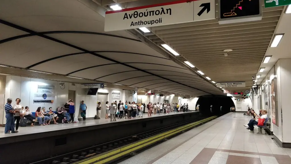 Passengers waiting along an underground platform at Syntagma metro station in Athens