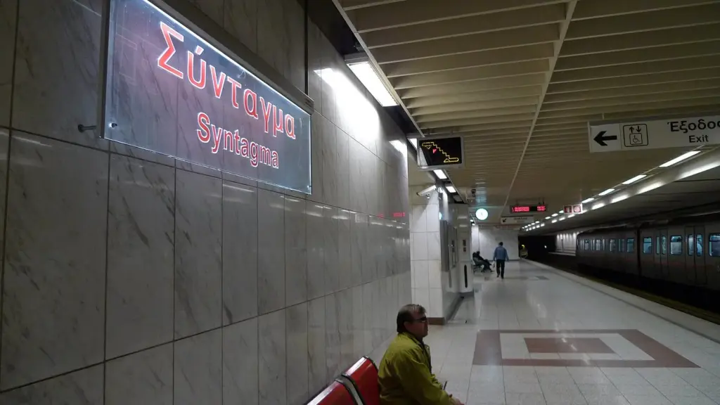 Syntagma metro station platform with the station name in Greek and English on the wall