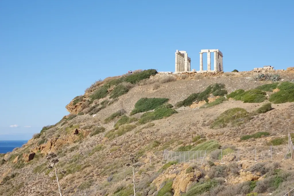 The Temple of Poseidon on the rocky headland at Cape Sounion above the sea