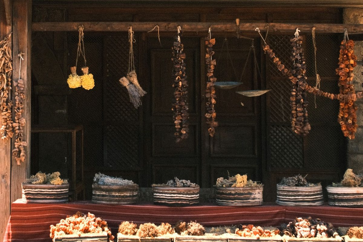 Dried herbs and roots hung by the sack. Oregano at a euro or two per 100g is the best-value thing in Athens.